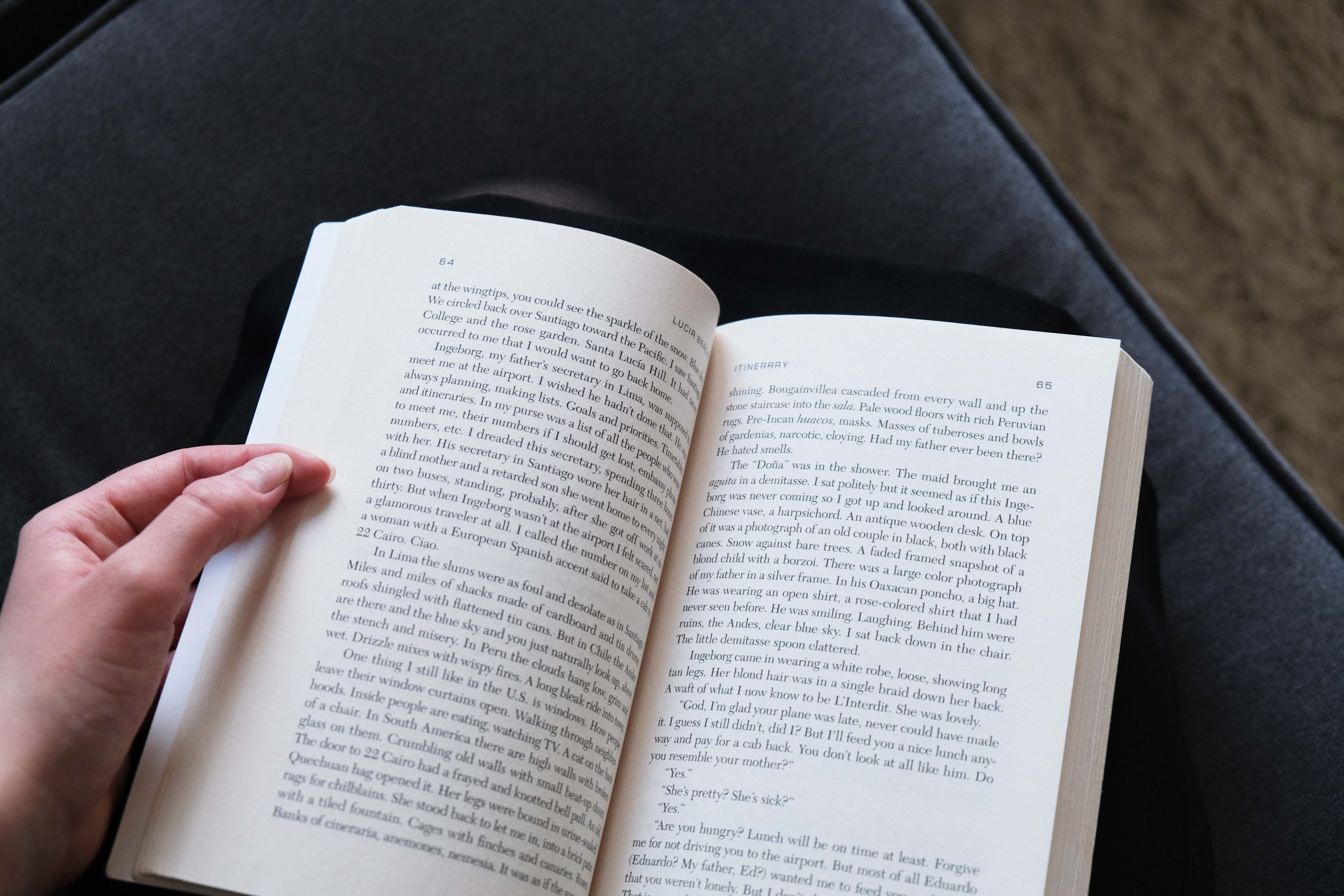 Reading Lucia Berlin's Evening in Paradise, an open book in a woman's hands